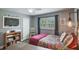 Comfortable bedroom featuring wood-look floors, natural light, and modern decor elements at 704 Tangerine Ct, Winter Garden, FL 34787