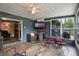Large Florida room features a ceiling fan, tiled floors, a TV, and access to the backyard at 704 Tangerine Ct, Winter Garden, FL 34787