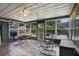 The screened in lanai offers tile floors, a ceiling fan, and views of the fenced backyard at 704 Tangerine Ct, Winter Garden, FL 34787