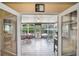 Bright Florida room has tile floors, ceiling fan, and lots of windows overlooking the backyard at 704 Tangerine Ct, Winter Garden, FL 34787