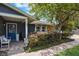 Charming front porch with brick flooring, bench seating, and a welcoming blue front door at 704 Tangerine Ct, Winter Garden, FL 34787