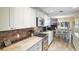 Well-lit kitchen featuring granite countertops, stainless appliances and white cabinets at 704 Tangerine Ct, Winter Garden, FL 34787