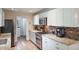 Modern kitchen with stainless appliances, granite countertops, and white cabinetry at 704 Tangerine Ct, Winter Garden, FL 34787