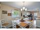 Eat-in kitchen features a wooden table with seating for four and bright natural light at 704 Tangerine Ct, Winter Garden, FL 34787