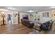 Spacious living room with wood flooring, comfortable leather furniture, and recessed lighting at 704 Tangerine Ct, Winter Garden, FL 34787