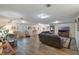 Spacious living room with wood floors, recessed lighting, and comfortable leather seating at 704 Tangerine Ct, Winter Garden, FL 34787