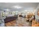 Spacious living area featuring wood-look flooring and a stylish bar, ideal for gatherings at 704 Tangerine Ct, Winter Garden, FL 34787