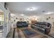 Large living room features wood floors, leather seating, and open floorplan at 704 Tangerine Ct, Winter Garden, FL 34787