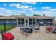 Backyard patio features a seating area with a fire pit, dining area, and grill for outdoor enjoyment at 704 Tangerine Ct, Winter Garden, FL 34787