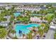 Aerial view of resort-style pools, beach volleyball, and other community amenities at 8518 Nemours Pkwy, Orlando, FL 32827