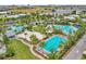Aerial view of neighborhood pools, sand volleyball, and recreation amenities at 8518 Nemours Pkwy, Orlando, FL 32827