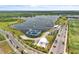 Aerial view of lake with an inflatable water park, a cable park, and a beach at 8518 Nemours Pkwy, Orlando, FL 32827