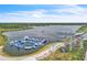 Aerial view of lake with inflatable water park, a cable park, and recreational activities at 8518 Nemours Pkwy, Orlando, FL 32827