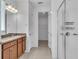 Spacious bathroom with double vanity, wood cabinets, tile floors, and a glass enclosed shower at 8518 Nemours Pkwy, Orlando, FL 32827