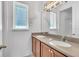 Bathroom featuring double sinks with modern fixtures and large mirror for shared use at 8518 Nemours Pkwy, Orlando, FL 32827