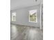 Bright room with hard wood flooring, windows with blinds, and neutral-colored walls at 8518 Nemours Pkwy, Orlando, FL 32827