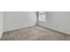 Bright bedroom with neutral carpet, baseboards, and a window offering natural light at 8518 Nemours Pkwy, Orlando, FL 32827
