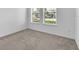 Neutral bedroom featuring carpet flooring and bright windows at 8518 Nemours Pkwy, Orlando, FL 32827