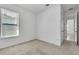 Bright bedroom with neutral carpet and a window offering natural light at 8518 Nemours Pkwy, Orlando, FL 32827