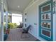 Welcoming front porch with stylish seating, a modern front door, and brick flooring at 8518 Nemours Pkwy, Orlando, FL 32827