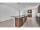 Open-concept kitchen with granite island, stainless steel appliances, and hardwood cabinetry at 8518 Nemours Pkwy, Orlando, FL 32827
