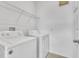 Functional laundry room with modern washer and dryer, and storage shelves for supplies at 8518 Nemours Pkwy, Orlando, FL 32827