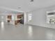 Open floor plan showcases the kitchen and living room with tile floors and lots of natural light at 8518 Nemours Pkwy, Orlando, FL 32827