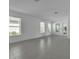 Spacious living room with many windows offering ample natural light and tile flooring at 8518 Nemours Pkwy, Orlando, FL 32827