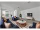 Stylishly decorated living room with blue sofas, a modern rug, and a white media center at 8518 Nemours Pkwy, Orlando, FL 32827
