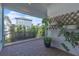 Inviting covered patio featuring pavers, lush greenery, and lattice wall at 8518 Nemours Pkwy, Orlando, FL 32827