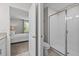 Bright bathroom featuring a glass enclosed shower, toilet and and a glimpse into the bedroom at 8822 Interlocking Ct, Davenport, FL 33896