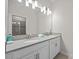 Bathroom boasting a double sink vanity and a large vanity mirror at 8822 Interlocking Ct, Davenport, FL 33896