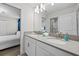 Bathroom boasting a double sink vanity and an adjacent door to the bedroom at 8822 Interlocking Ct, Davenport, FL 33896