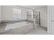 Bathroom showcasing a soaking tub and a separate glass-enclosed shower at 8822 Interlocking Ct, Davenport, FL 33896