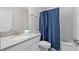 Bathroom featuring a single sink vanity with blue shower curtain at 8822 Interlocking Ct, Davenport, FL 33896