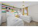 bedroom featuring twin beds and colorful Disney cartoon themed wall art at 8822 Interlocking Ct, Davenport, FL 33896
