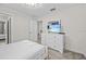 Inviting bedroom with soft carpet, a TV, and a dresser for organizing clothes at 8822 Interlocking Ct, Davenport, FL 33896
