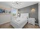 Bright bedroom features stylish lighting, bedside tables, and decorative wall art at 8822 Interlocking Ct, Davenport, FL 33896