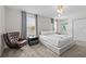 Bright bedroom featuring a king bed, modern light fixture, and stylish accent chair at 8822 Interlocking Ct, Davenport, FL 33896