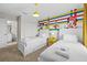 bedroom featuring twin beds and colorful Disney cartoon themed wall art at 8822 Interlocking Ct, Davenport, FL 33896