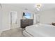 Bedroom with a large TV, dresser, and access to the bathroom at 8822 Interlocking Ct, Davenport, FL 33896