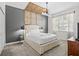 Charming bedroom with a decorative wood ceiling and modern lighting fixtures at 8822 Interlocking Ct, Davenport, FL 33896