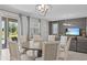 Inviting dining area with a circular table, comfortable seating, and a seamless transition to the living room at 8822 Interlocking Ct, Davenport, FL 33896