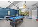 View of game room features an air hockey table, pool table, and themed murals at 8822 Interlocking Ct, Davenport, FL 33896