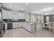 Open-concept kitchen features sleek countertops, stainless steel appliances, and breakfast bar seating at 8822 Interlocking Ct, Davenport, FL 33896