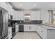 Modern kitchen featuring stainless steel appliances, ample cabinet space, and a stylish tile backsplash at 8822 Interlocking Ct, Davenport, FL 33896