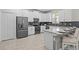 Well-equipped kitchen with stainless steel appliances, a breakfast bar, and modern white cabinetry at 8822 Interlocking Ct, Davenport, FL 33896