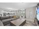 Bright living room features an open floor plan, modern lighting, and tile flooring throughout at 8822 Interlocking Ct, Davenport, FL 33896