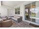 Cozy covered patio with wicker seating, offering a relaxing outdoor space next to the pool at 8822 Interlocking Ct, Davenport, FL 33896