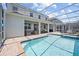 Backyard features a screened pool area with outdoor seating and dining at 8822 Interlocking Ct, Davenport, FL 33896